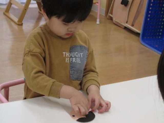 画像：紙で遊ぶ園児